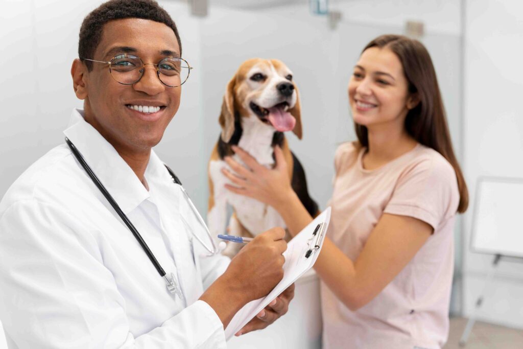 A smiling male veterinarian with a Beagle and its owner, illustrating Wastol Express Limited's focus on pet health.
